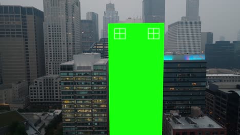 Green-screen-on-skyscraper-in-urban-city-in-USA-during-foggy-dusk