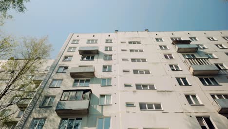 Highrise-prefab-panel-Soviet-apartment-facade-with-window-and-balcony-low-angle-dolly-in