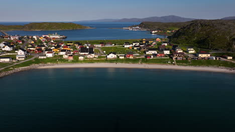 Aerial-view-away-from-the-Pykeija-village,-midnight-sun-in-Finmark,-Norway