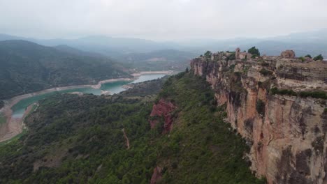 Siurana,-a-historical-village-atop-a-cliff-overlooking-a-river-in-tarragona,-aerial-view