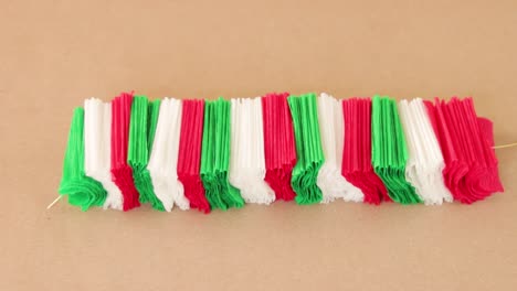 Papercraft-DIY-art-crepe-paper-stacked-on-string-in-Mexican-flag-colors