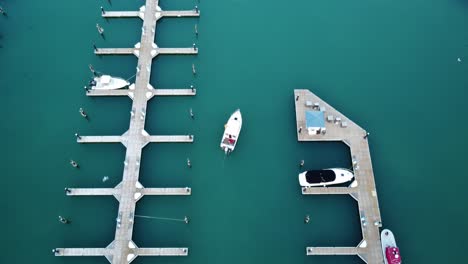 Aerial-Drone-Tracking-A-Small-Boat-Leaving-The-Marina-Of-Port-Washington-Harbor,-Wisconsin,-USA