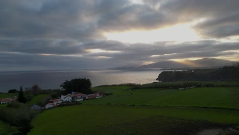As-the-sun-ascends,-its-golden-hues-envelop-the-hills-and-coastal-expanse-of-the-Portuguese-Riviera-in-Açores,-Portugal,-capturing-the-essence-of-coastal-beauty-and-tranquility-in-the-landscape