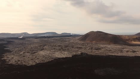 Inhospitable-volcanic-rock-landscape-with-smoking-gas-vents-and-mounds