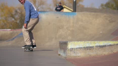 person-does-a-switch-heel-nose-slide-big-spin-a-ledge-at-the-skatepark