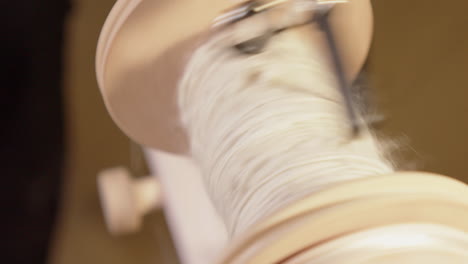 Spinning-close-up:-Wool-spins-into-yarn-on-spinning-wheel-bobbin