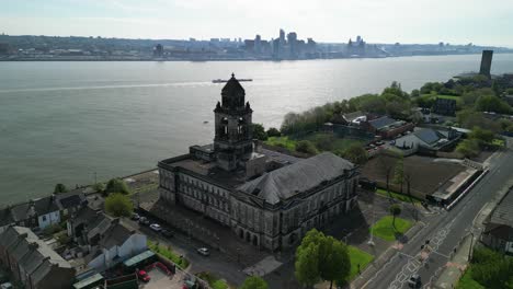 Wallasey-Town-Hall-iconic-landmark---aerial-drone-clockwise-rotate-and-move-in,-Liverpool-cityscape-silhouette-background,-Wirral,-UK