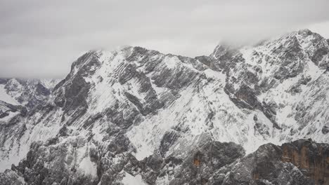 Eine-Dünne-Schneeschicht-Auf-Den-Dunklen-Gestellen,-Luftaufnahme-Der-österreichischen-Alpen