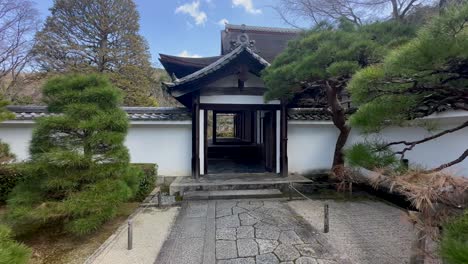 Walk-through-a-gate-on-a-porch-to-Tenjuan-Buddhist-Temple,-Kyoto,-Japan