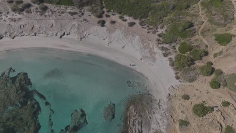 Perspective-of-Tranquil-Exploration-Drone-above-Hidden-Cala-Sa-Torreta-Beach-Cliff-in-Menorca-Spain