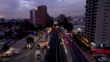 AERIAL:-Front-of-a-subway,-leaving-a-Metro-station,-evening-in-Santiago-de-Chile