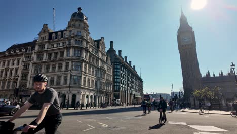 Cyclists-Going-Past-Along-Streets-Of-Parliament-Square-In-Westminster-On-Sunny-Bright-Morning