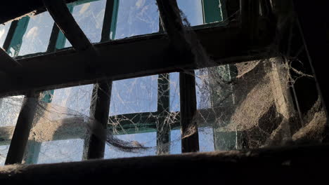 Alcatraz-Prison-Detail,-Inside-View-of-Cobweb-and-Dust-on-Metal-Bars-and-Window-on-Sunny-Day,-California-USA