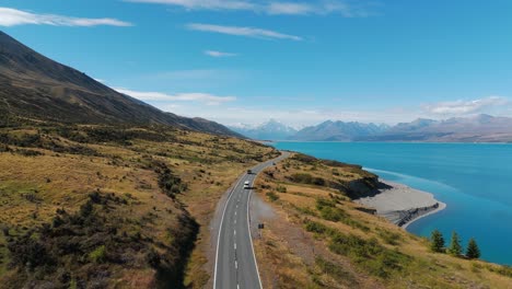 Camper-van-road-trips-across-New-Zealand-driving-along-Lake-Pulak,-aerial