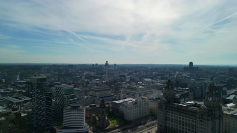 Stunning-aerial-flyover-of-Liverpool-city-centre-away-from-River-Mersey-waterfront-on-a-sunny-morning---iconic-buildings,-England,-UK