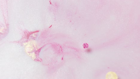 Close-up-of-vibrant-pink-ink-diffusing-in-water,-creating-a-dynamic-abstract-pattern