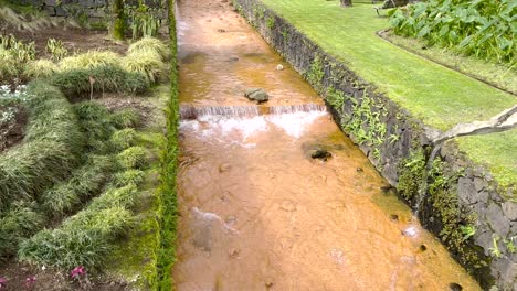 Gently-sloping,-golden-toned-thermal-pools-at-Poca-da-Dona-Beija,-nestled-in-Furnas,-Sao-Miguel,-within-the-picturesque-Azores-of-Portugal