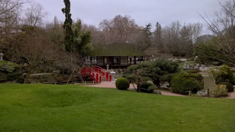 Una-Foto-De-Un-Jardín-Japonés-Con-Un-Puente-Rojo.