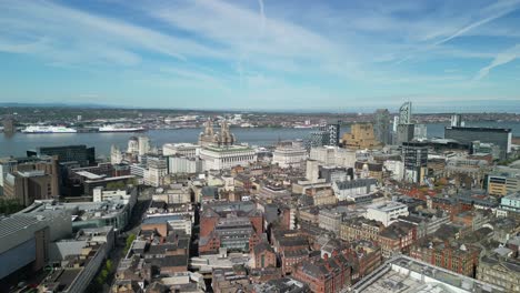 Stunning-aerial-flyover-of-Liverpool-city-centre-towards-River-Mersey-waterfront-on-a-sunny-morning---iconic-buildings,-England,-UK