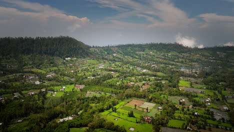 Aerial-establishing-dolly-above-scenic-valley-lowlands-of-Mount-Batur-Bali