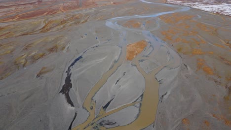 Confluence-of-muddy-rivers-in-brown-glacial-plains-with-mud-and-silt