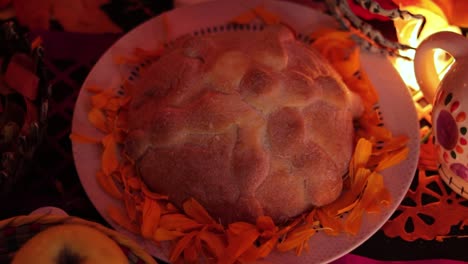Bread-of-the-dead-on-marigold-petals,-offering-altar,-Mexico