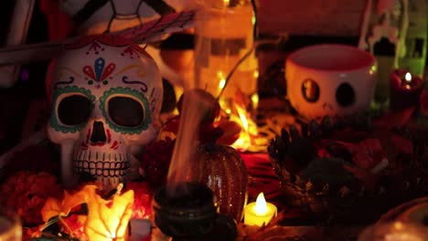 Sugar-skull-and-traditional-offerings-for-Day-of-the-Dead,-dark-ambience-close-up