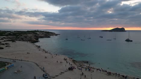 cala-comte-beach-with-boats,-stunning-ibiza-sunset-sky