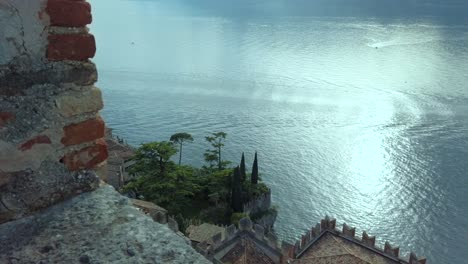 Marvel-at-Lake-Garda's-beauty-from-a-castle-wall,-offering-a-unique-perspective