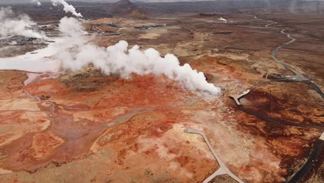 Gunnhuver-hot-springs-in-iceland,-showcasing-vibrant-geothermal-activity,-aerial-view