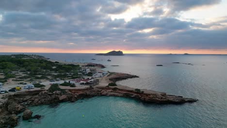 cala-comte-beach-with-boats,-stunning-ibiza-sunset-sky