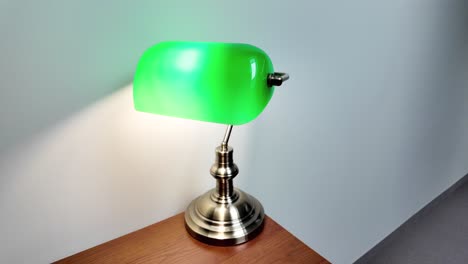 Green-Reading-Lamp-On-Wooden-Desk-In-The-Library