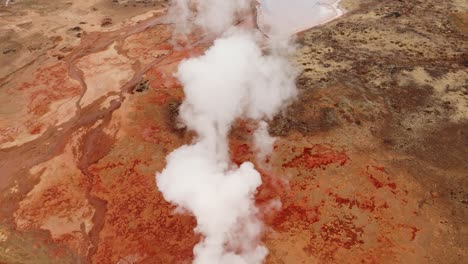 Vapor-Que-Sale-De-Las-Vívidas-Aguas-Termales-De-Gunnhuver-En-Islandia,-Vista-Aérea