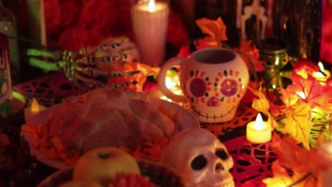 Day-of-the-Dead-table-with-offerings-of-food-and-sugar-skulls,-establisher