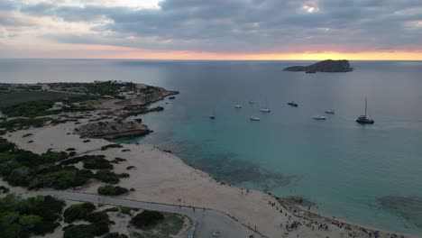 cala-comte-beach-with-boats,-stunning-ibiza-sunset-sky
