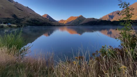 Berge-Und-Blauer-Himmel-Spiegeln-Sich-Im-Ruhigen-Wasser-Des-Moke-Lake-Mit-Morgendlichem-Nebel