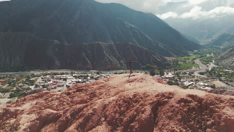Wooden-cross-on-Cerro-Siete-Colores-in-the-tourist-town-of-Purmamarca,-Jujuy,-Argentina
