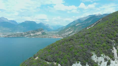 Breathtaking-vista-of-Torbole,-Lake-Garda,-amidst-nature's-splendor-with-towering-rocks,-expansive-sky,-and-ever-changing-clouds,-offering-an-invigorating-hiking-adventure-in-Lomba