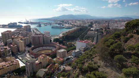 Aerial-view-of-Malaga-with-the-sea,-port-and-mountains-surrounding-it