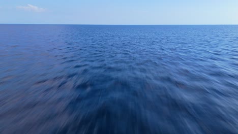 Aerial-dolly-on-empty-ocean-water-surface-with-calming-sea-texture