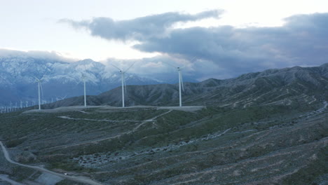 Windmills-turbine-rotating,-wind-farm-or-power-plant,-green-renewable-energy-generators,-Joshua-tree-National-park,-California,-USA