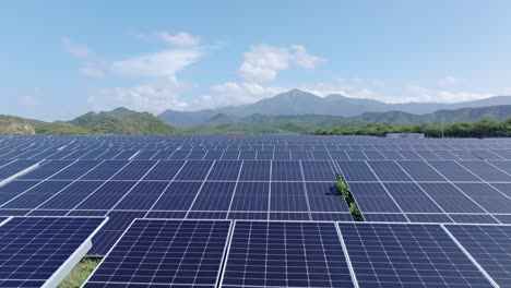 Flying-Above-Photovoltaic-Panels-On-Solar-Field-In-Bani,-Dominican-Republic