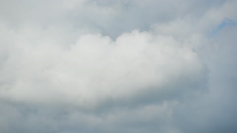 Daytime-timelapse-of-fluffy-clouds-racing-across-a-blue-sky