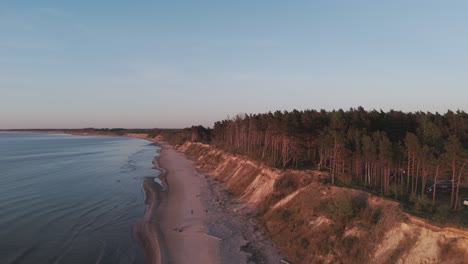 Establishing-Aerial-Shot-of-Coastline-Baltic-Sea-Jurkalne-on-Evening-at-Sunset