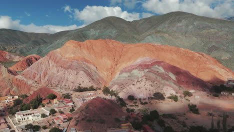 Aerial-drone-view-of-Cerro-Siete-Colores-in-Purmamarca,-UNESCO-World-Heritage-Site,-Jujuy,-Argentina