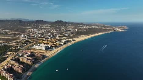Aerial-view-backwards-over-the-coastline-of-Cabo-San-lucas,-sunny-day-in-Mexico