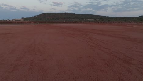 Drone-clip-moving-forwards-over-iron-rich-red-earth-in-Australian-outback