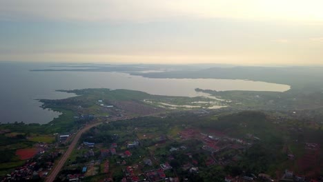 Scenic-View-of-a-Countryside-Town-Nestled-Along-the-Shores-of-Lake-Victoria,-Kampala,-Uganda,-East-Africa---Aerial-Drone-Shot