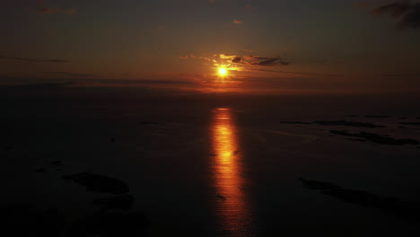 Aerial-tracking-shot-of-midnight-sun-above-the-Atlantic-sea,-summer-in-Norway