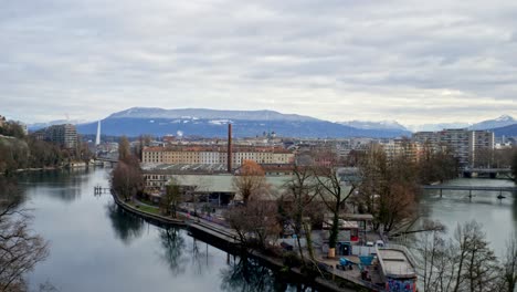 A-panorama-of-an-industrial-zone-of-the-Geneva-city,-showing-at-the-foreground-the-Rhone-river,-and-in-the-background-the-jet-d´Eau-and-the-alps